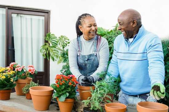 A couple enjoys gardening outside, exhibiting the joy that can come from combining God's health principles.