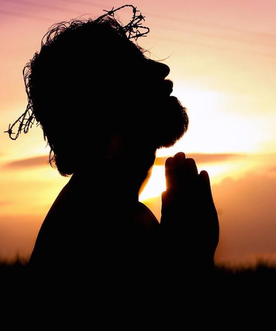 A silhouette of Jesus with a crown of thorns on His head