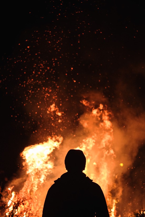 A man standing in front of a fire, similar to the burning bush Moses saw