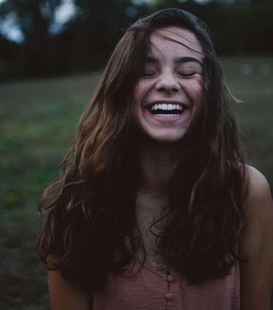 A young woman expressing joy because of her relationship with Jesus