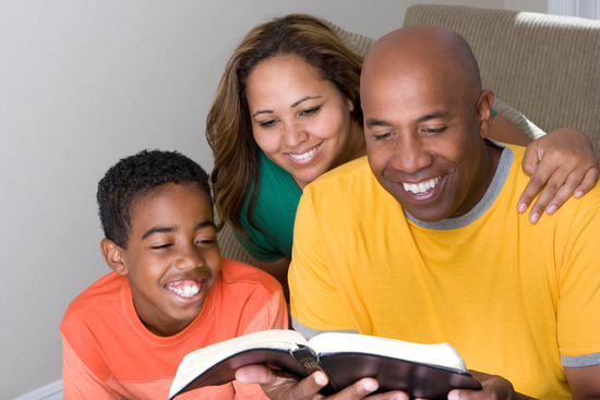 An African multicultural family reading the Bible together