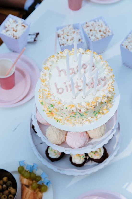 A birthday cake sitting on a table with other snacks and treats to celebrate the special occasion