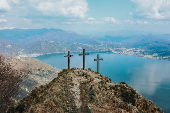 Three crosses on a hill overlooking a lake