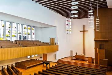 Empty Church wooden pews in ground floor and balcony with a large cross in front - AAAF