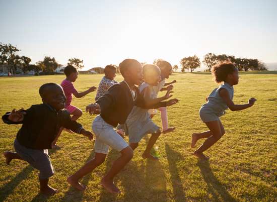 A group of children running in a field