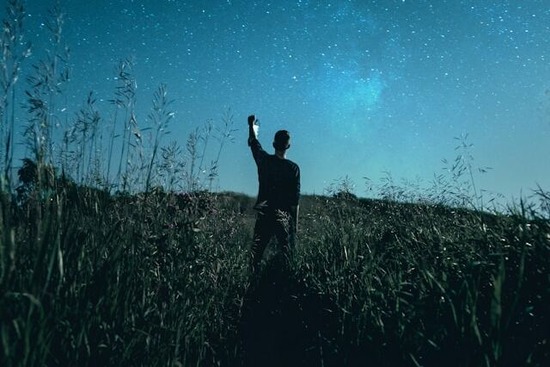 A man under a starry sky, as though he might be a prophet receiving a vision