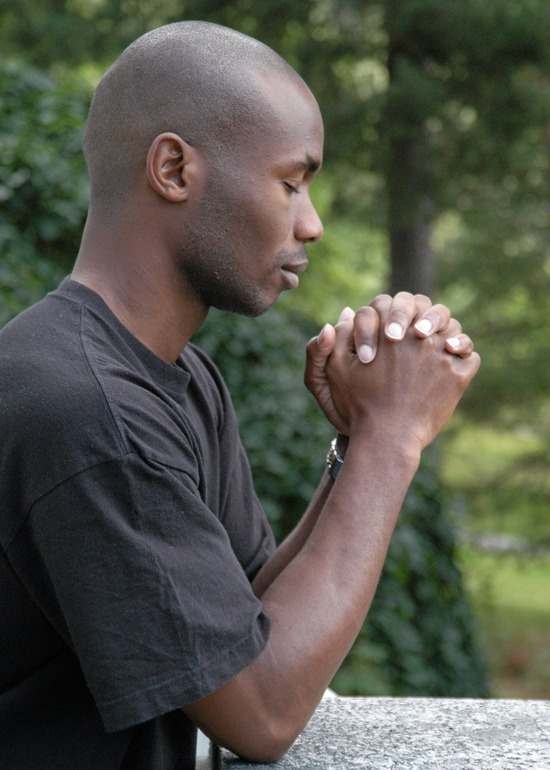 Man with hands close-up in prayer