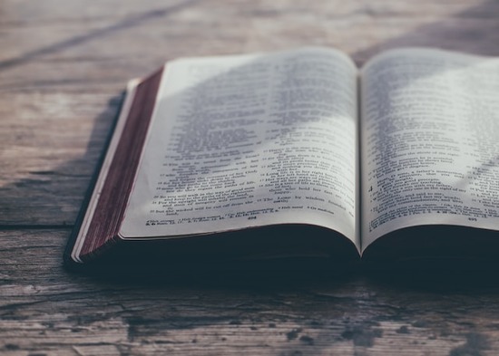 A Bible open on a wooden table