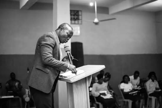 An Adventist pastor preaching from a pulpit in church