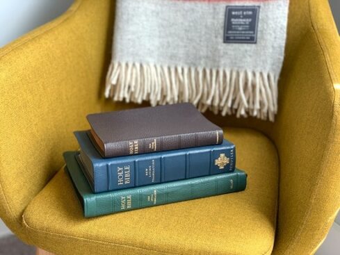 Stack of Bibles on Yellow chair