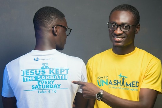 Two young men, wearing shirts that highlight keeping the Sabbath on Saturday. One shirt reads, 